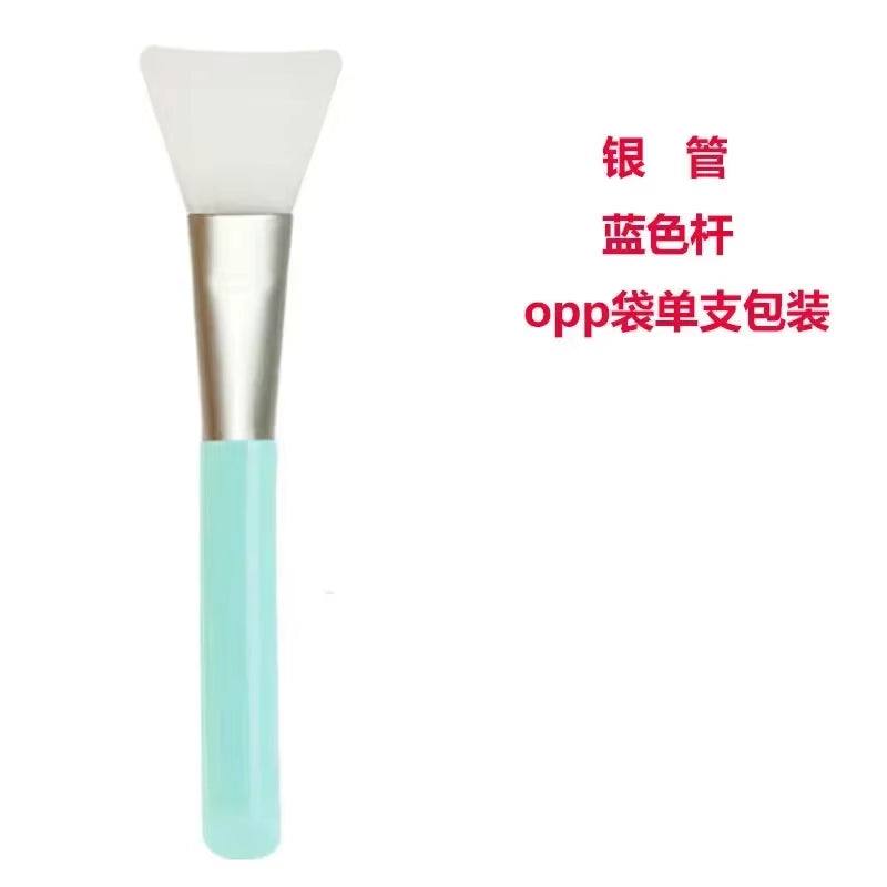 Silicone facial mask brush with soft blue handle, perfect for applying skincare products.