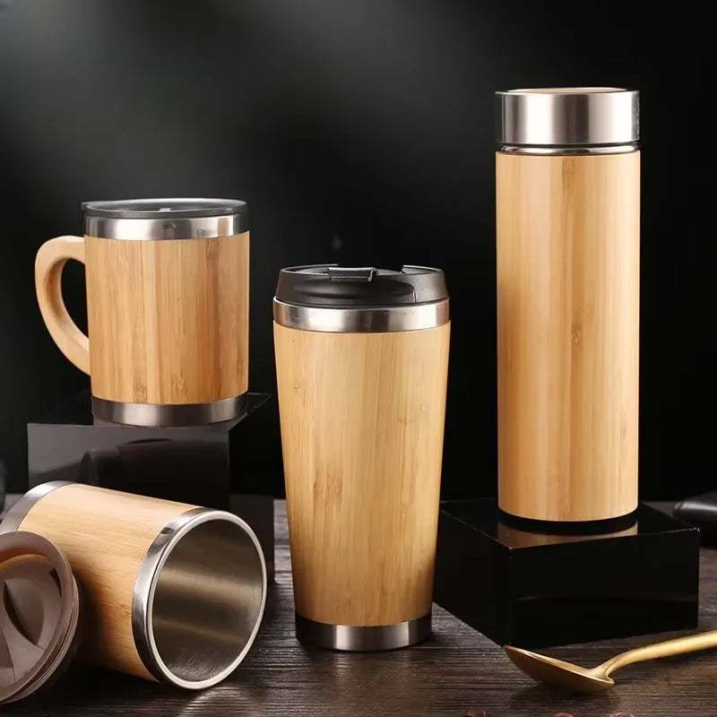 Eco-friendly travel cup mug set made of stainless steel and natural bamboo, featuring vacuum insulation and a spill-resistant flip-top lid.