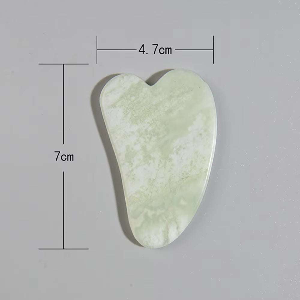 Natural jade Gua Sha scraper for face and body massage, measuring 7cm by 4.7cm, ideal for enhancing skincare routine and reducing puffiness.