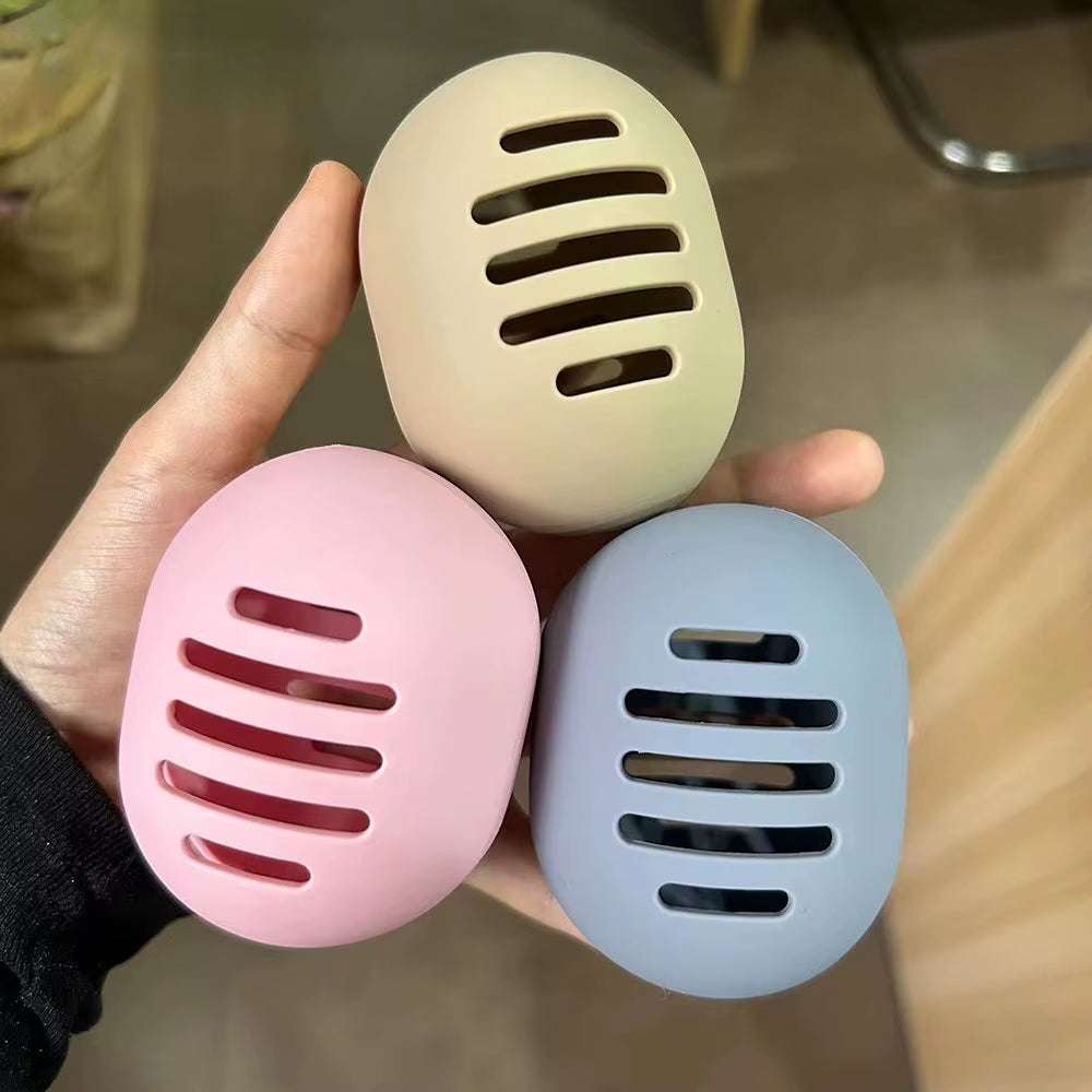 Eco-friendly silicone makeup sponge holders in beige, pink, and gray with ventilated design for hygiene and portability.