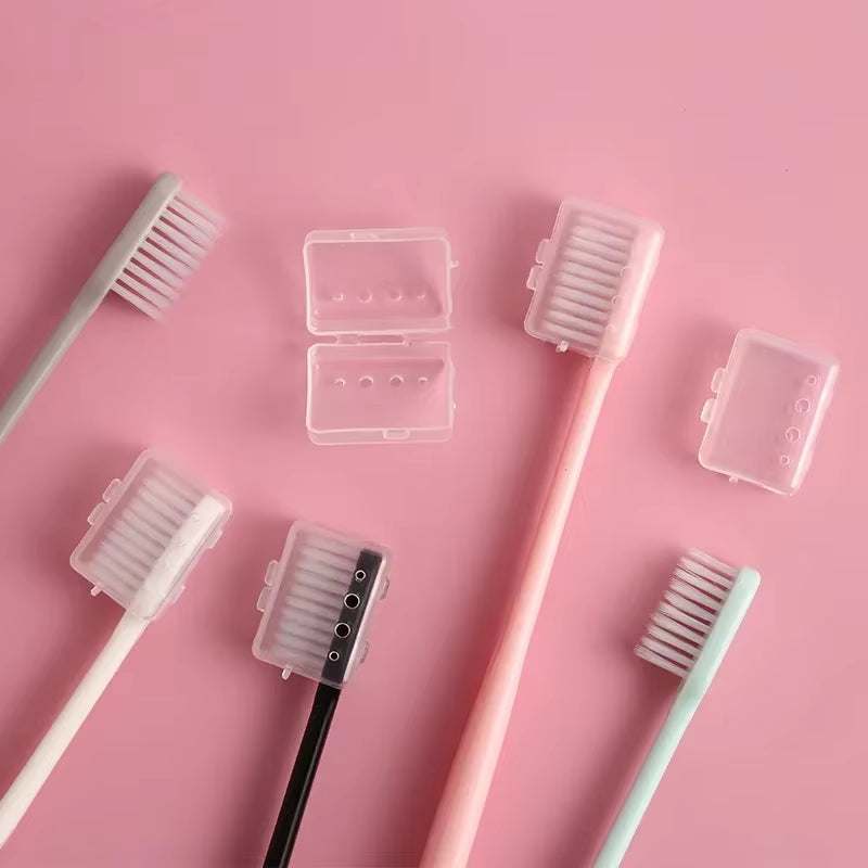 Eco-friendly bamboo charcoal toothbrush set with a natural finish and black bristles on a pink background.