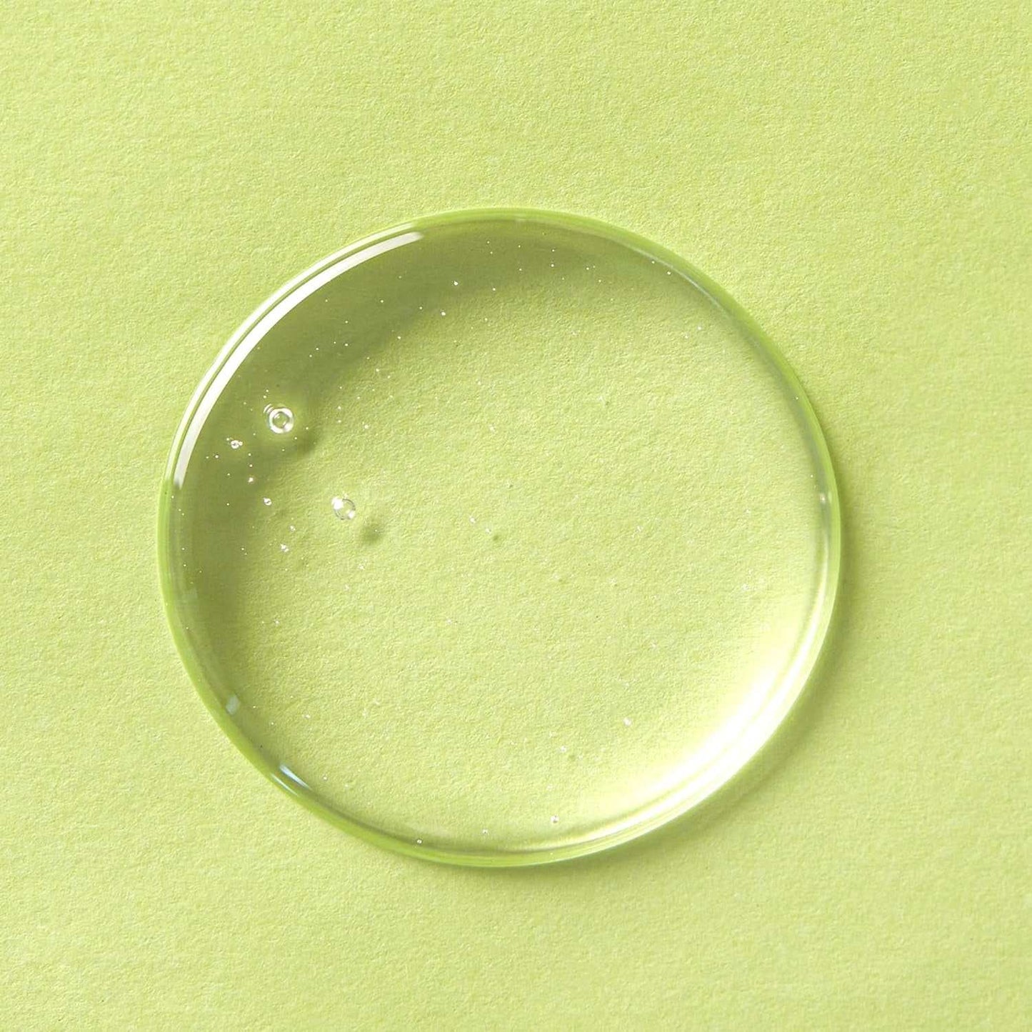 Clear drop of cleansing oil on light green background for facial cleanser product