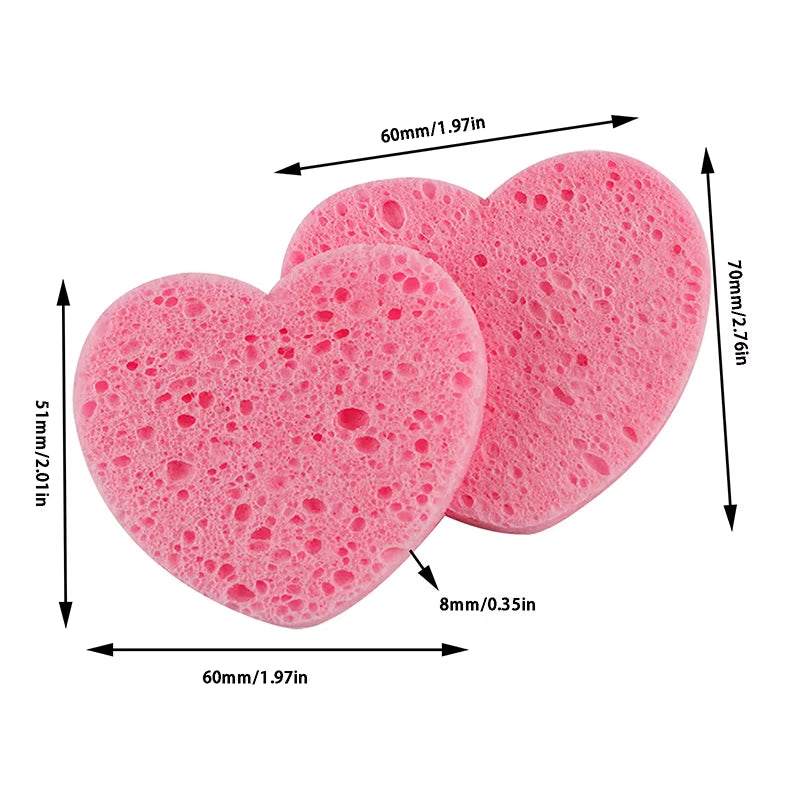 Heart-shaped pink makeup remover sponges made from natural wood pulp, perfect for facial cleansing and exfoliation.