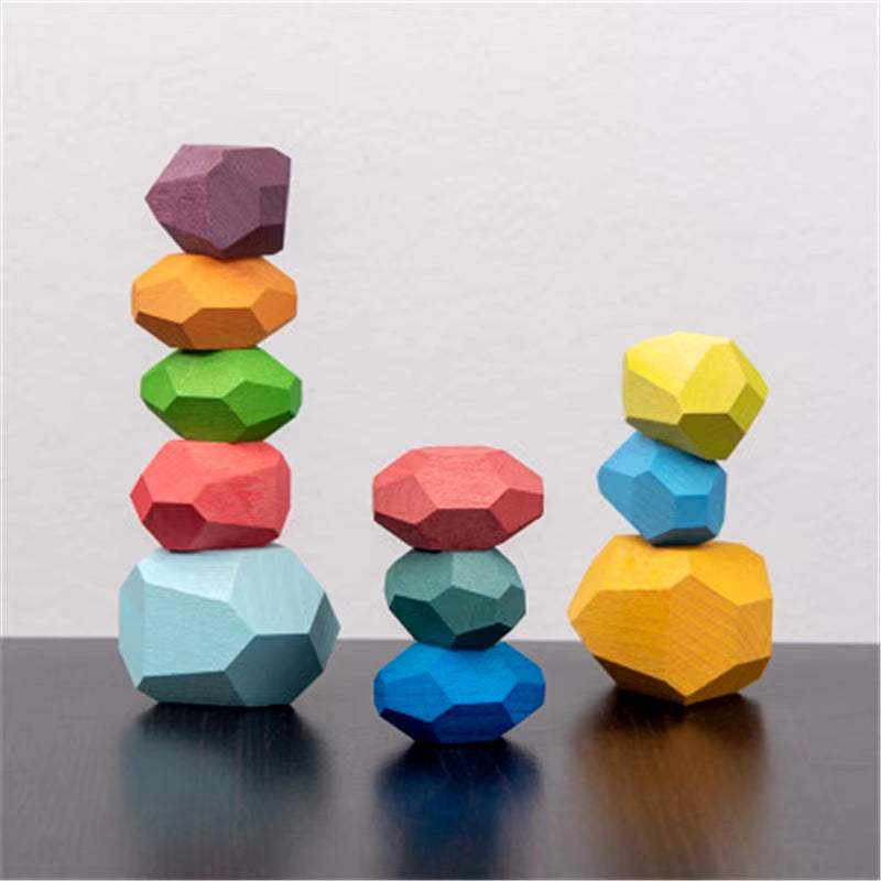 Colorful wooden sensory stacking rocks for toddlers on a table, promoting educational and tactile play.