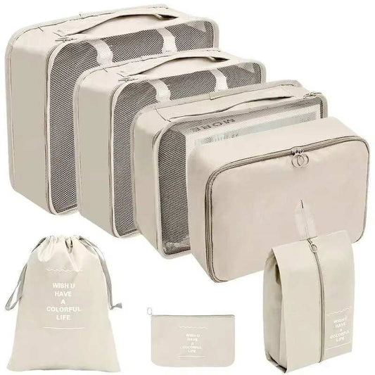 Travel organizer storage bag set with multiple sizes, including packing cubes, laundry bags, and pouches, in cream color.