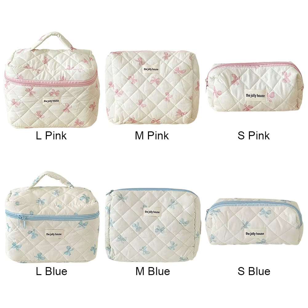 Quilted floral pattern makeup bags in pink and blue, available in three sizes with bow accents.