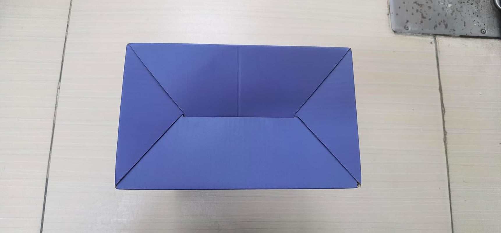 Blue packaging box for pet stainless steel water fountain on tiled floor