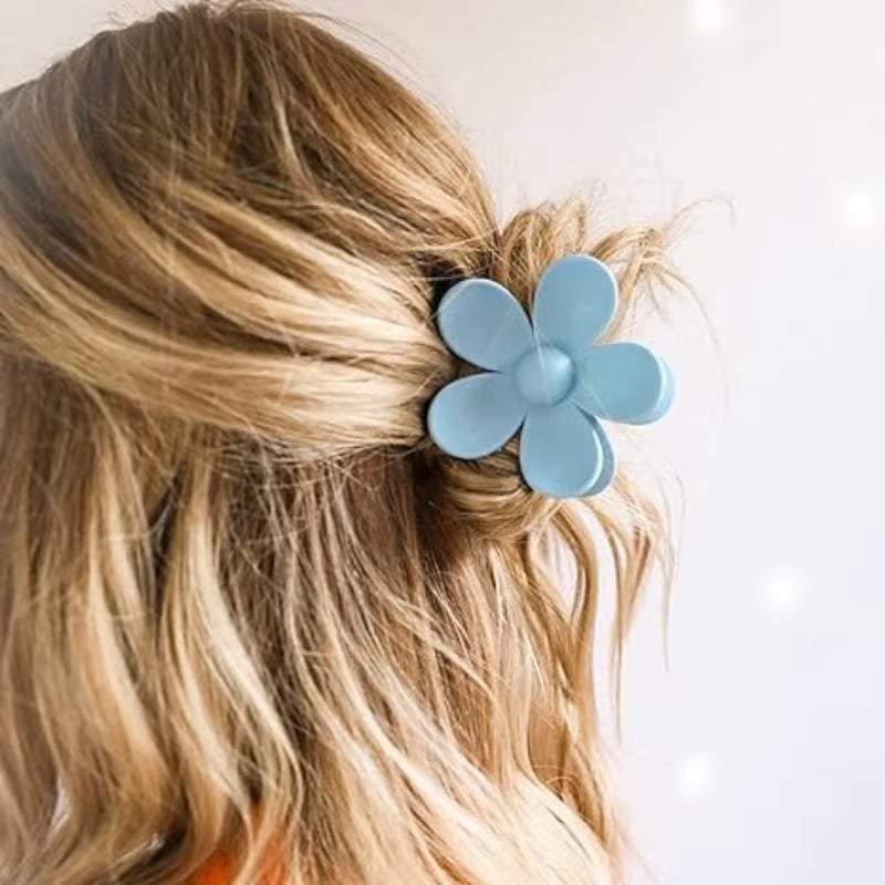 Blue flower hair clip, styled in wavy hair, from the 6Pcs Spa Headband and Wristband Set for skincare and beauty routines.