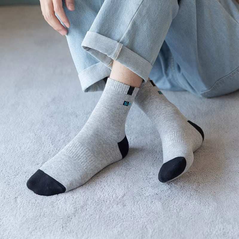Breathable cotton sport sock for men, grey with black toe and heel, worn with casual jeans.