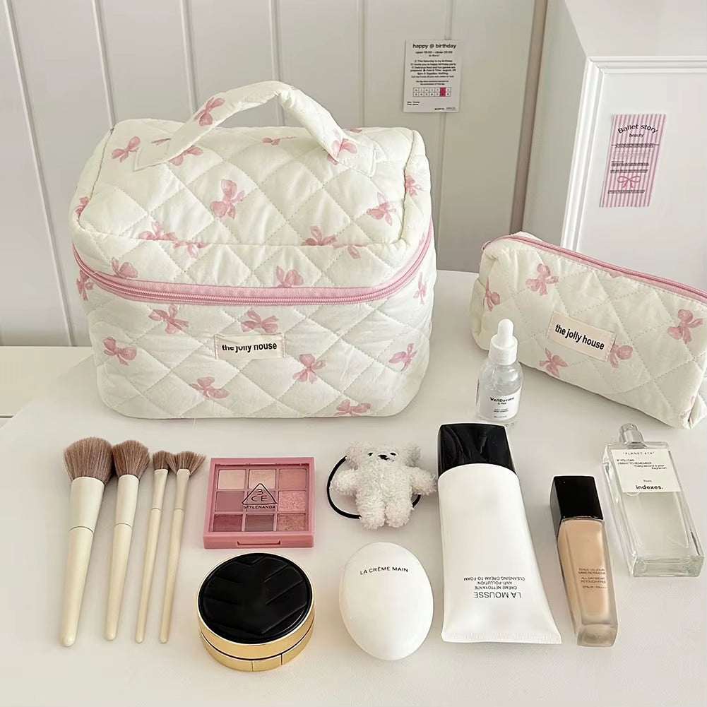 Flower cloth portable makeup bag with quilted cotton design, floral pattern, and bow accent; includes spacious interior, secure zipper closure, and easy-clean fabric.