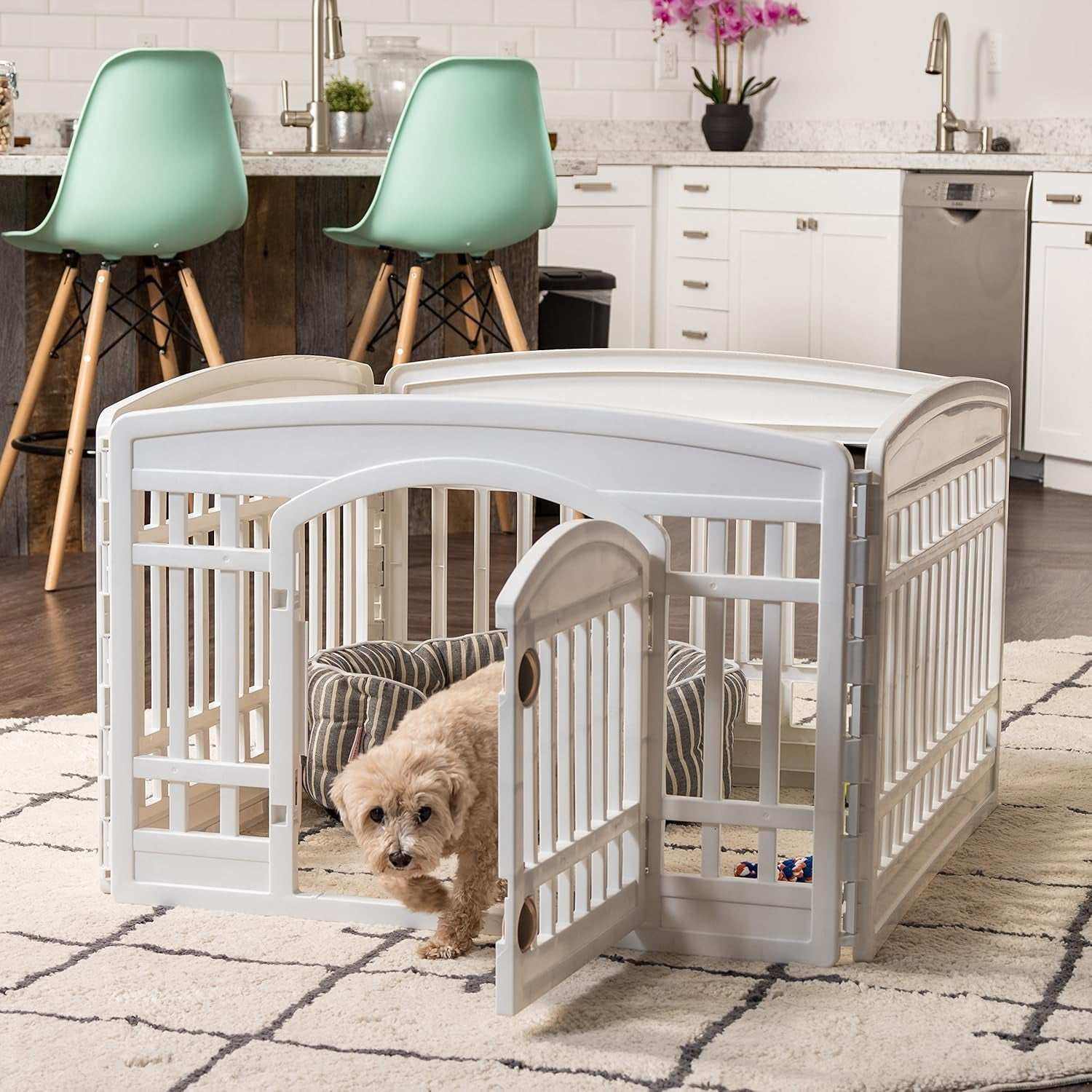 White pet exercise playpen door panel with a small dog inside, placed in a modern kitchen setting
