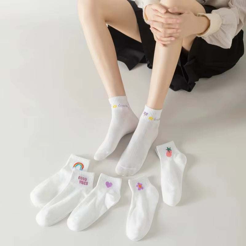 women's white ankle socks with fun smiling face design and colorful patterns