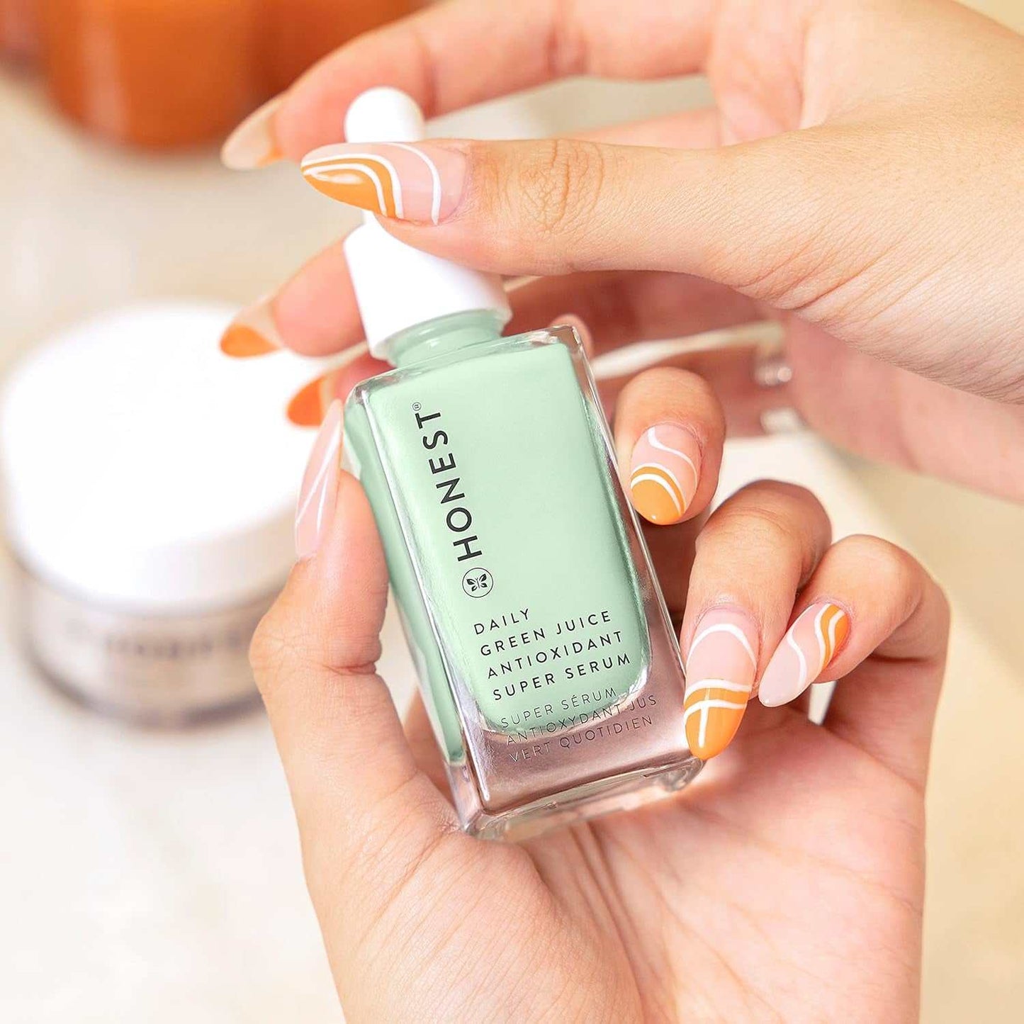 Cruelty-free antioxidant super serum bottle held in hand, ideal for hydration and brightening.