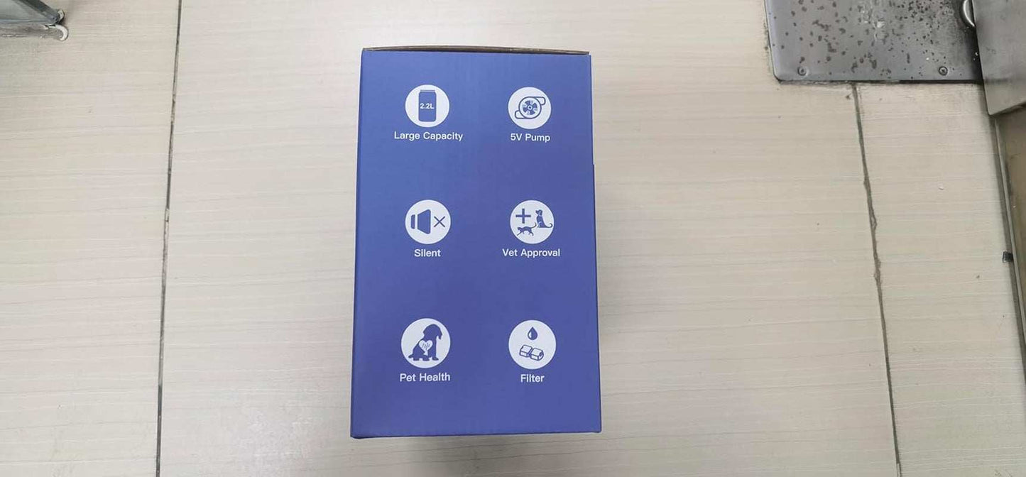 Blue pet stainless steel water fountain packaging box showing features like large capacity, silent pump, vet approval, pet health, and filter icons.