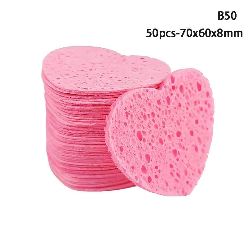 Heart-shaped pink makeup remover sponges made from natural wood pulp, set of 50, ideal for gentle facial cleansing and exfoliation.