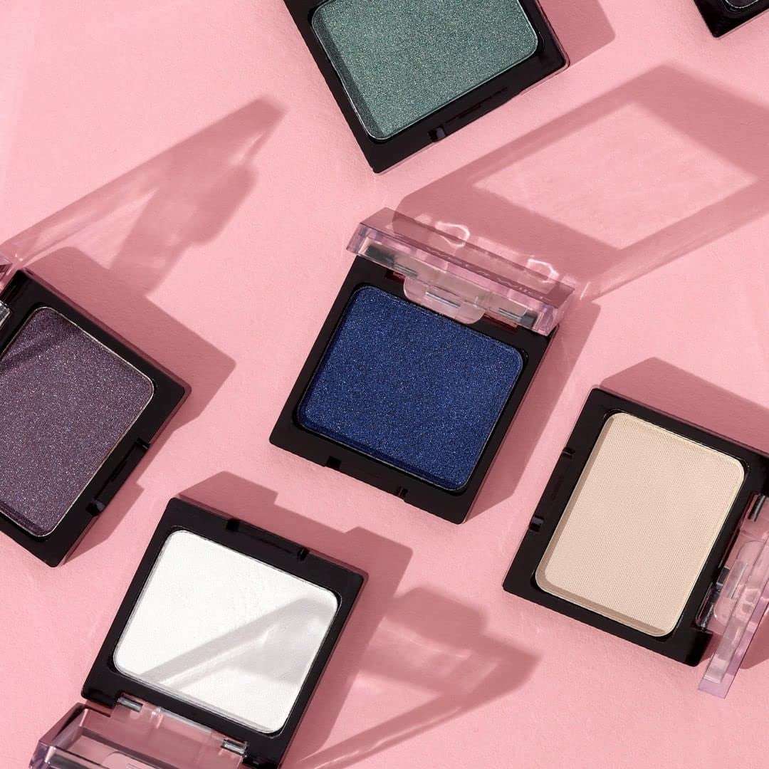 Ultra-pigmented eyeshadow palette featuring vibrant shades in green, blue, purple, white, and beige with a smooth texture and long-lasting wear