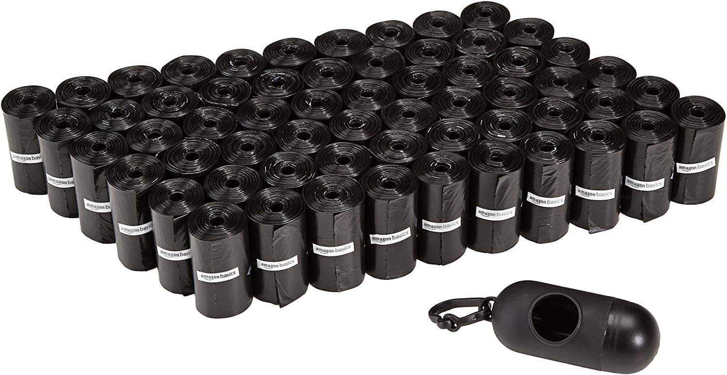 Black dog leak-proof poop bags in multiple rolls with a dispenser and leash clip for easy waste disposal during walks