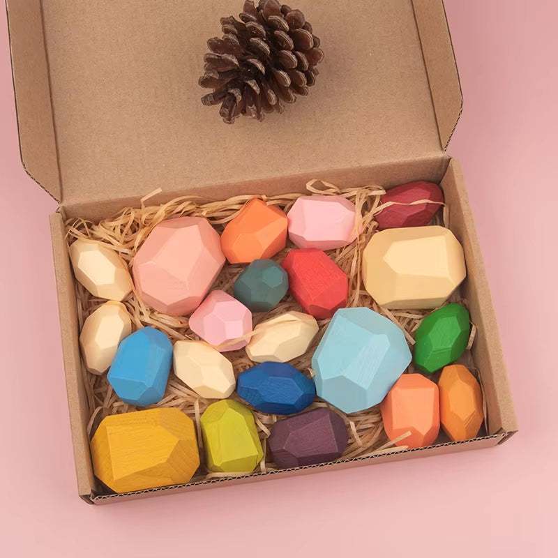 Colorful wooden sensory stones set in a box, ideal for toddler learning and play.