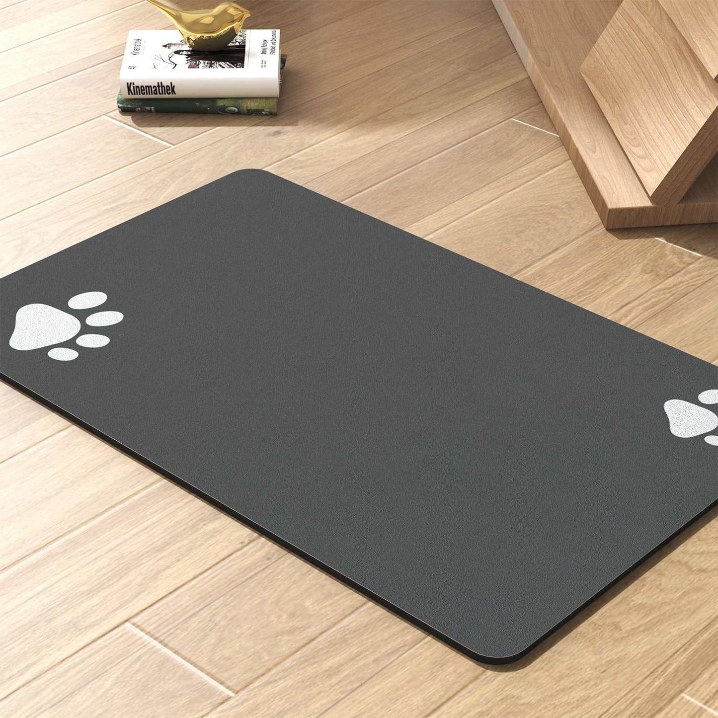 Non-slip gray pet feeding mat with paw prints, quick-dry and absorbent for food and water bowls.