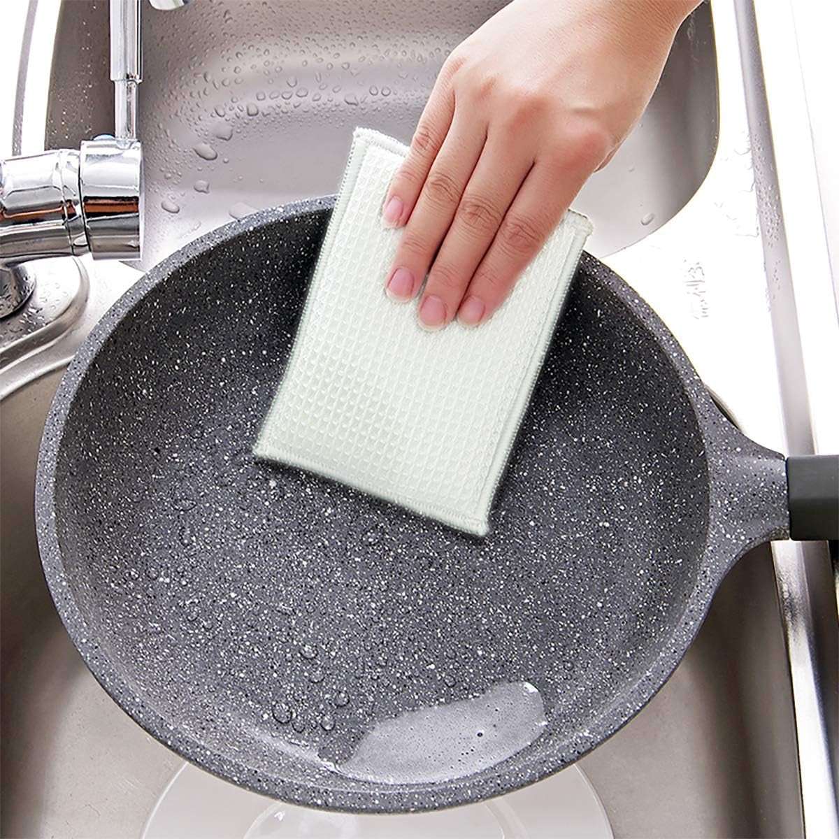 Bamboo Dish Sponge cleaning a non-stick pan.
