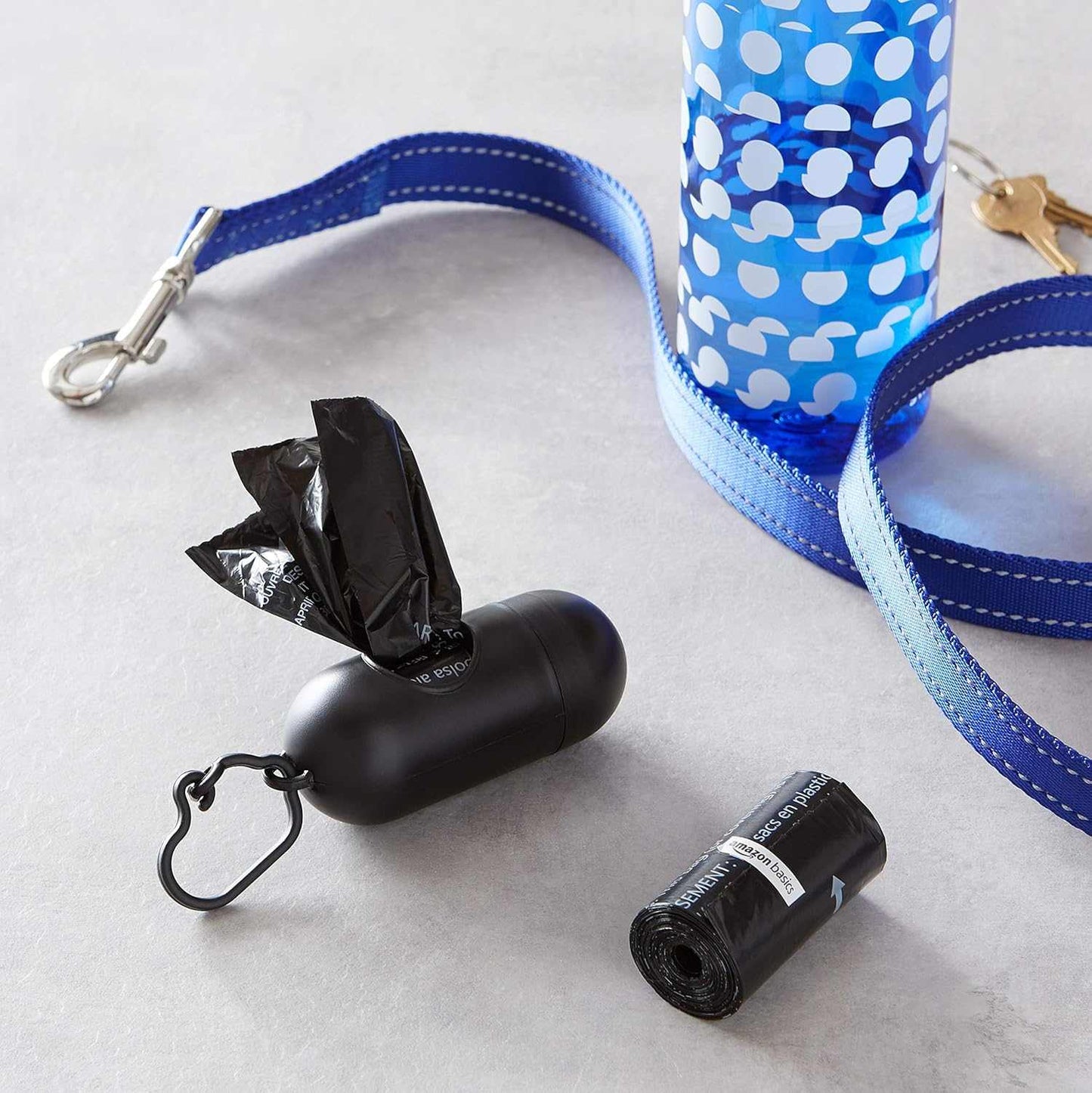 Black dog leak-proof poop bags with dispenser and leash clip for easy waste disposal during walks