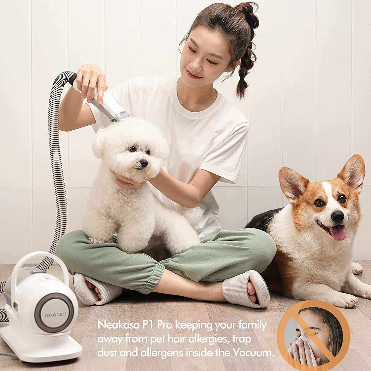Woman grooming white fluffy dog with Neakasa P1 Pro pet grooming vacuum featuring powerful clippers and vacuum suction, with a brown corgi sitting nearby.