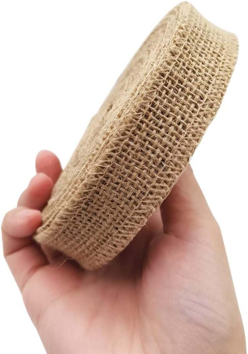 Natural fabric burlap ribbon roll held in hand, ideal for home decoration and crafts.