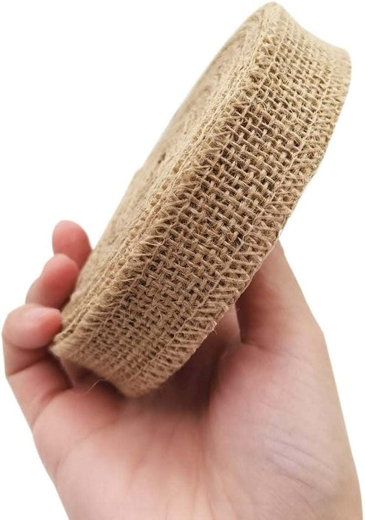 Natural fabric burlap ribbon roll held in hand, ideal for home decoration and crafts.