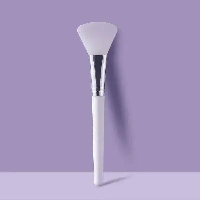 Silicone facial mask brush with soft, flexible head for skincare application.