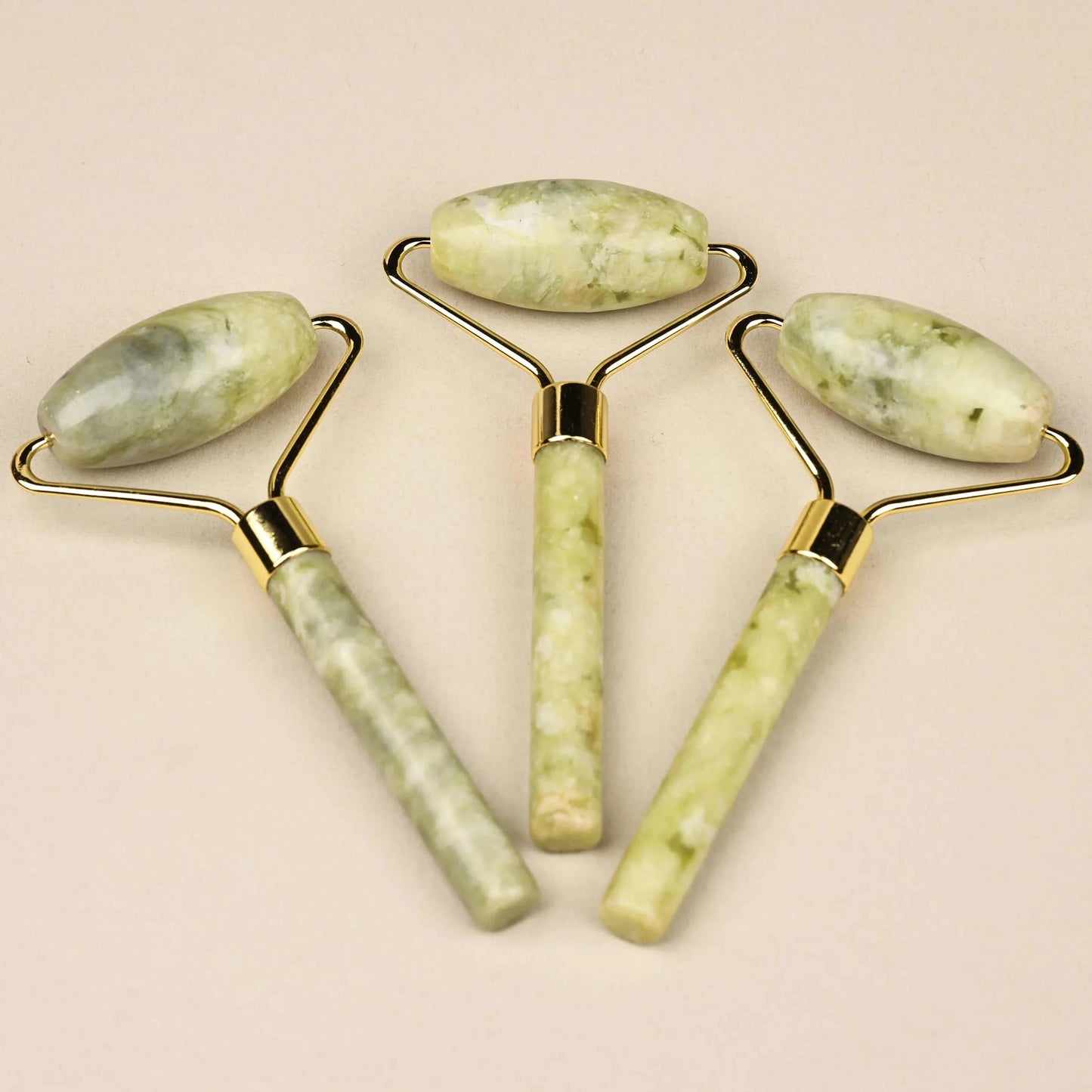 Natural jade face roller set for skincare, enhancing blood circulation and reducing puffiness.
