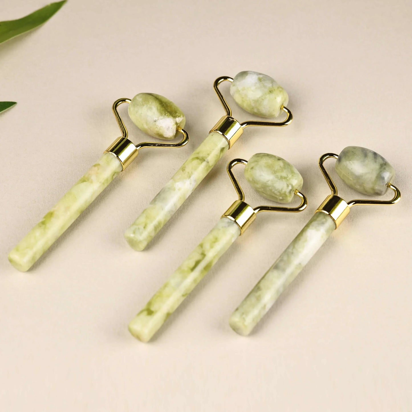 Natural jade face roller set for skincare massage and puffiness reduction.