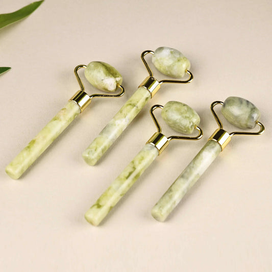 Natural jade face roller set for skincare massage and puffiness reduction.