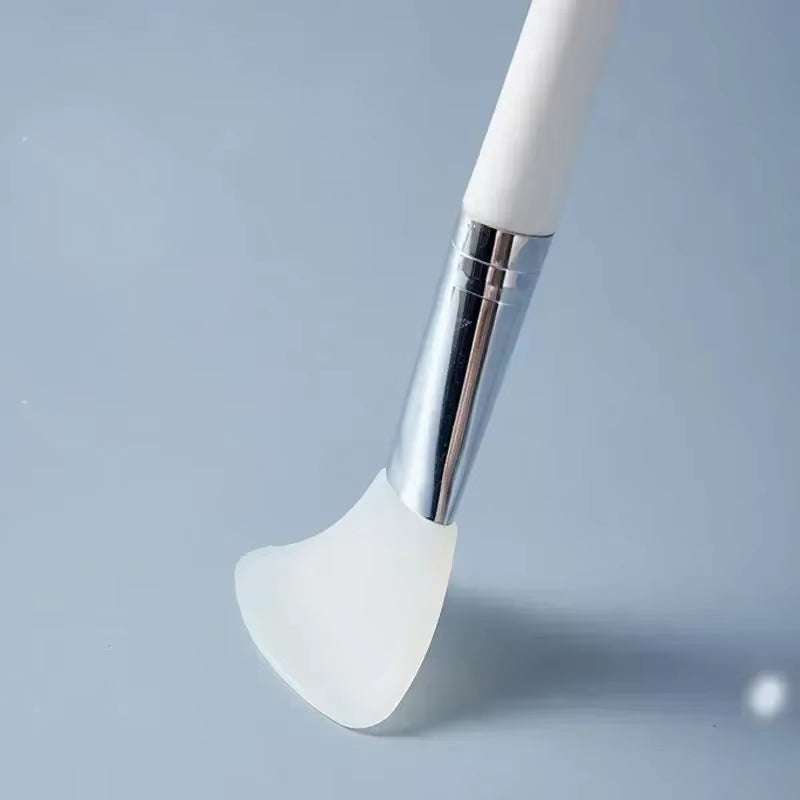 Silicone facial mask brush with soft head and durable handle for skincare application.