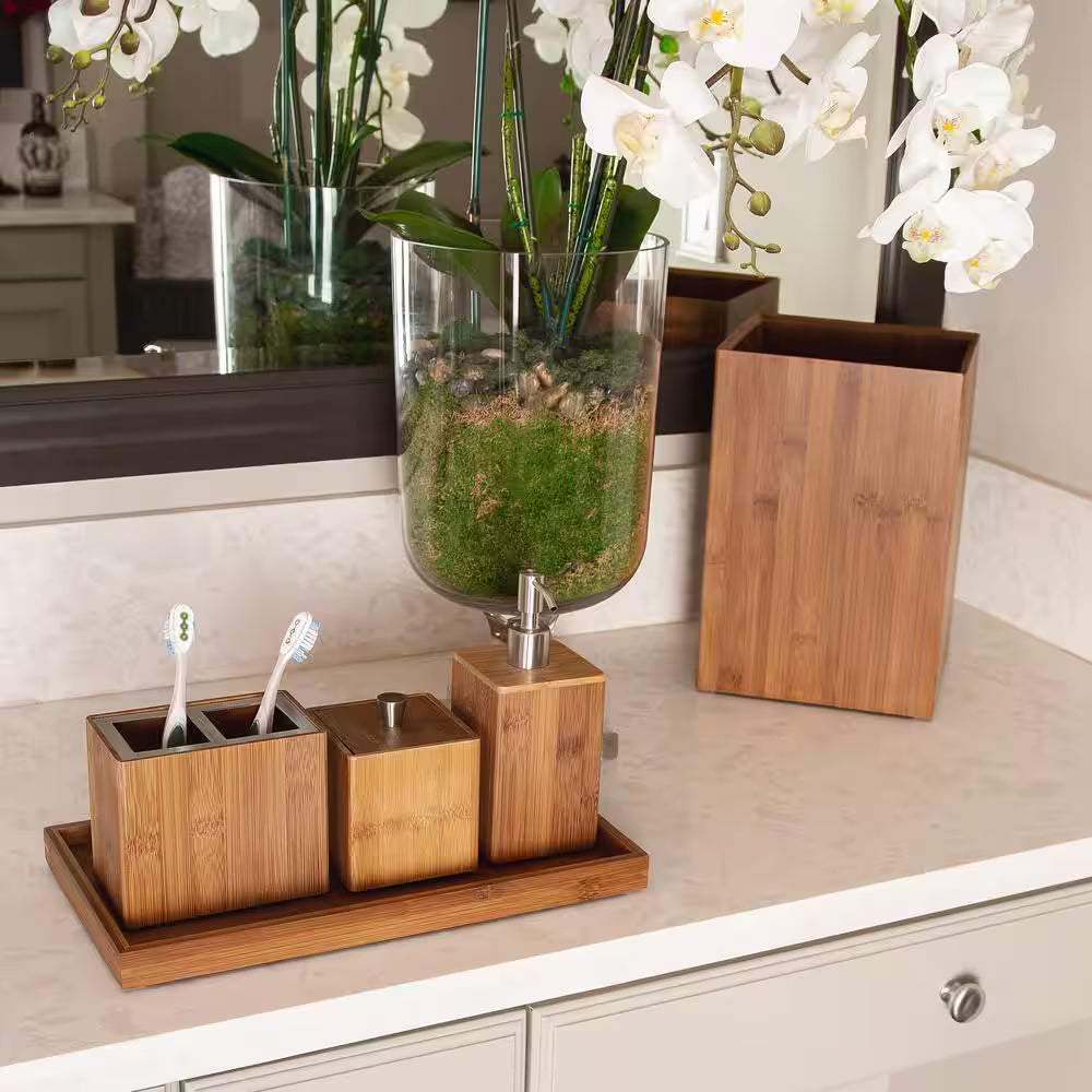 Bamboo Waste Basket 5-piece set with wastebasket, pump dispenser, toothbrush holder, cotton swab container, towel holder on elegant countertop.