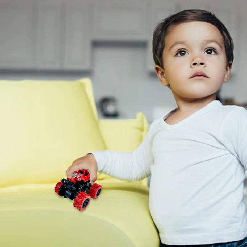 Child playing with a red kids' 360-degree rotation car toy on a yellow couch.