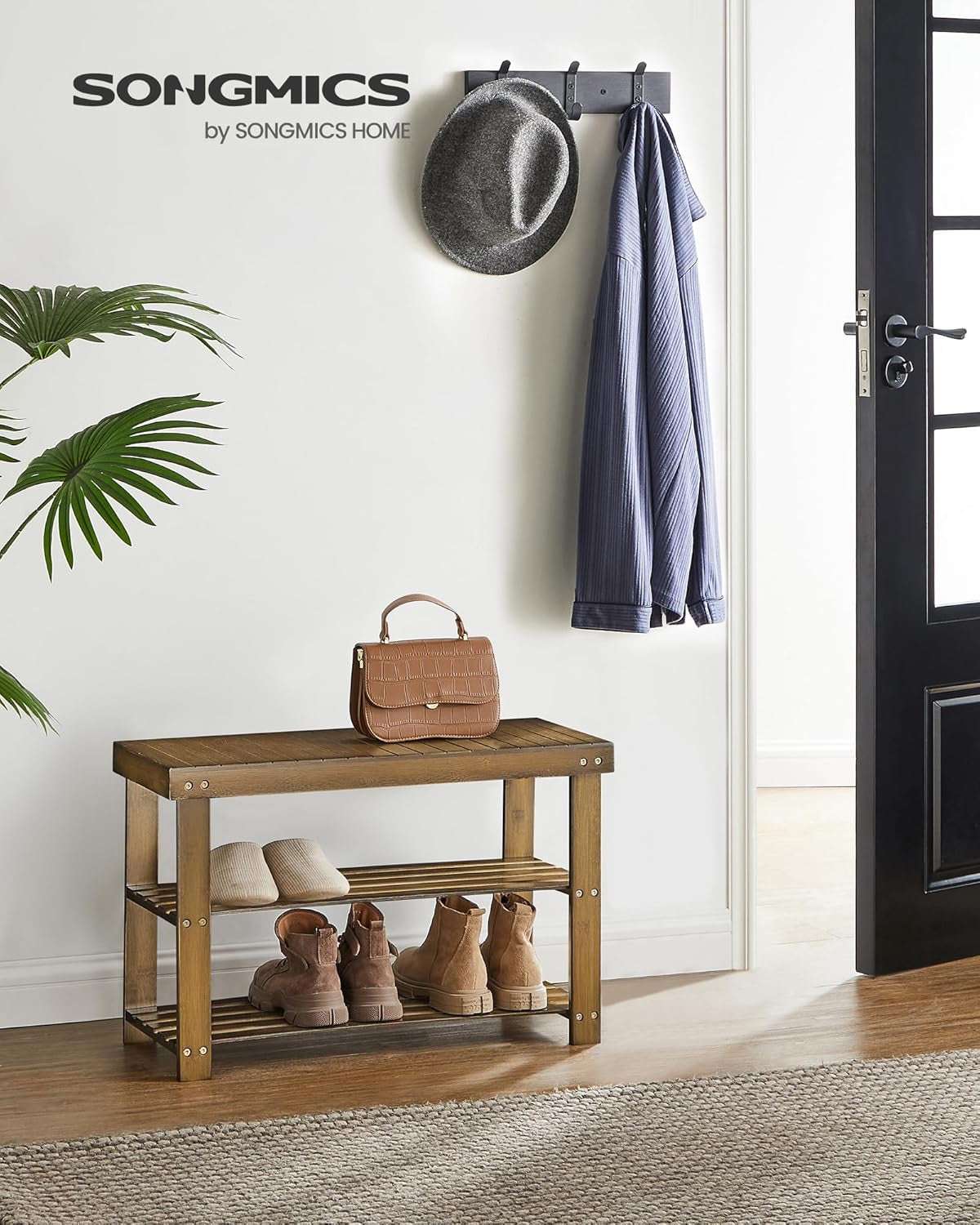 Stylish three-tier bamboo shoe rack bench in an entryway with shoes and a handbag.