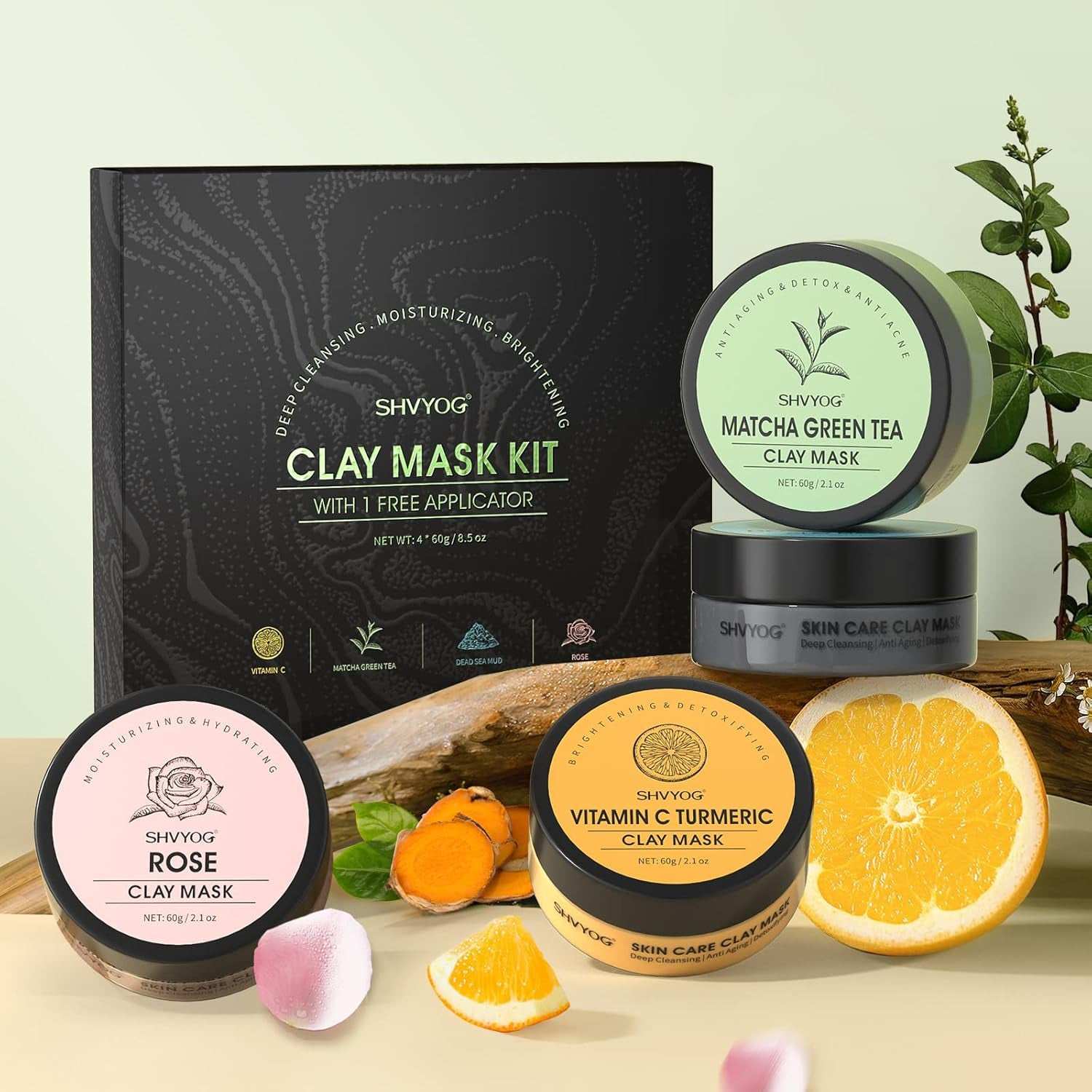 Four piece clay facial mask set with Vitamin C, Turmeric, Green Tea, and Rose displayed with packaging and natural ingredients.