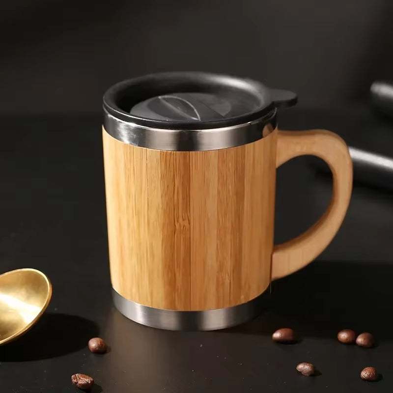 Eco-friendly travel cup with bamboo exterior and stainless steel accents, featuring a leak-proof flip-top lid.