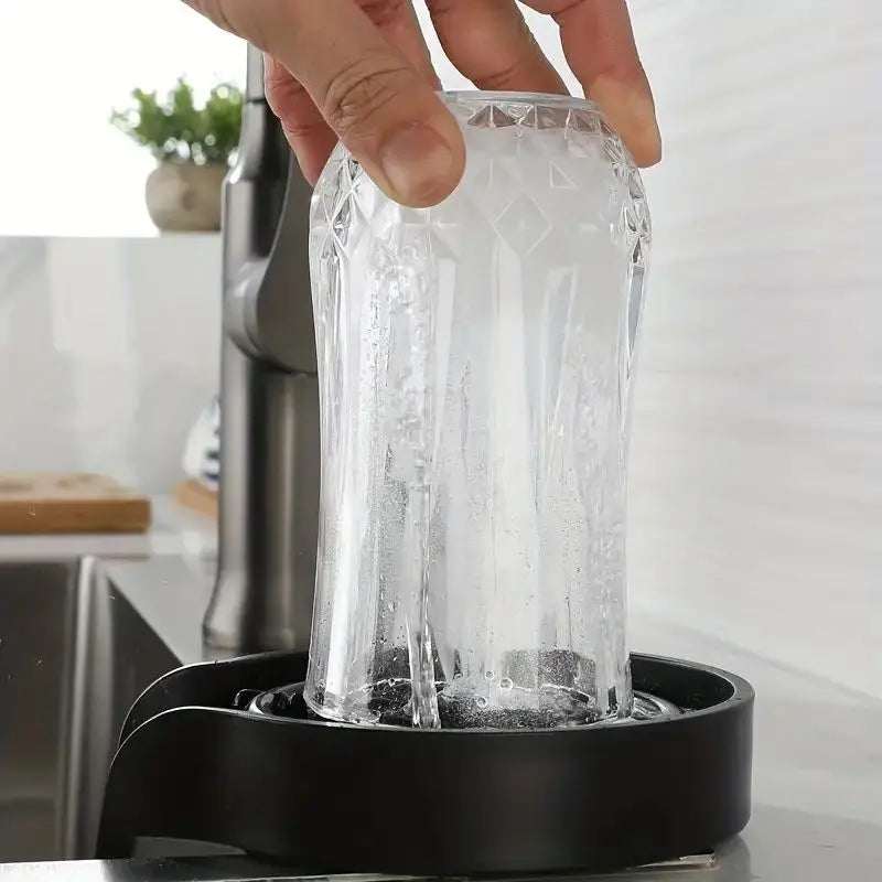 High Pressure Automatic Cup Washer in action, cleaning a glass with powerful water jets at a kitchen sink.