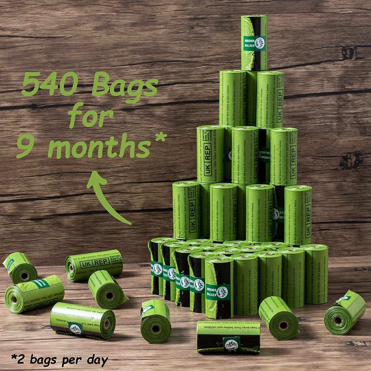 Green rolls of poop bags for dog waste stacked in a pyramid on a wooden surface with text indicating 540 bags for 9 months use