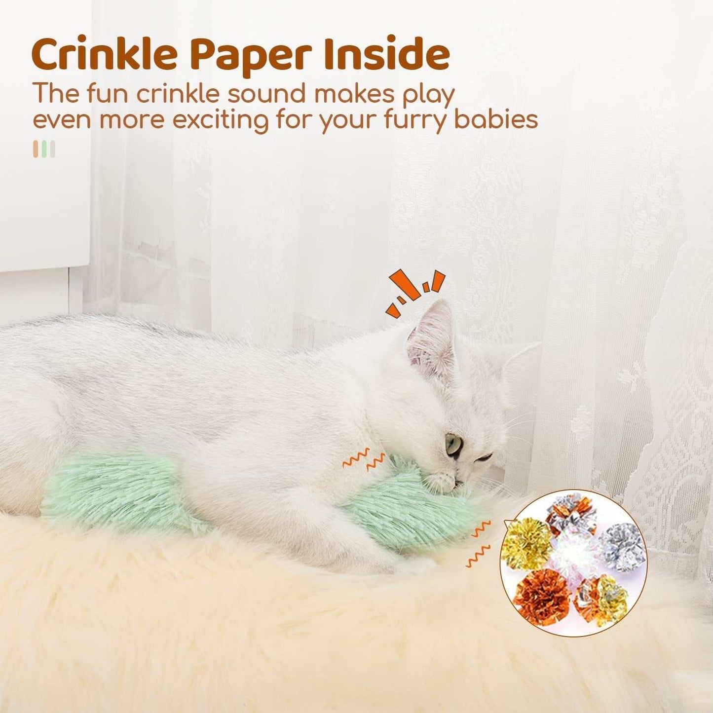 White cat playing with crinkle sound catnip cat toy on a soft surface indoors