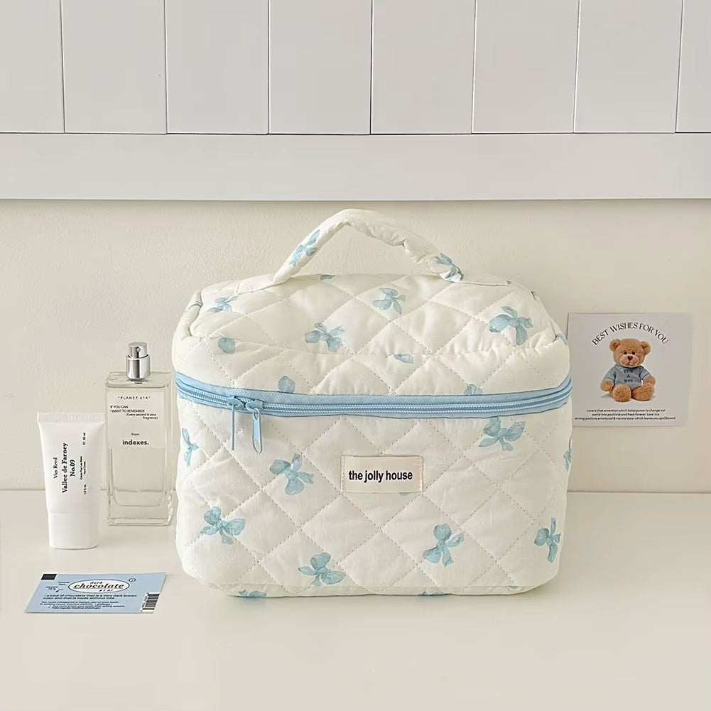 Quilted floral makeup bag with zipper, lightweight and portable for travel.