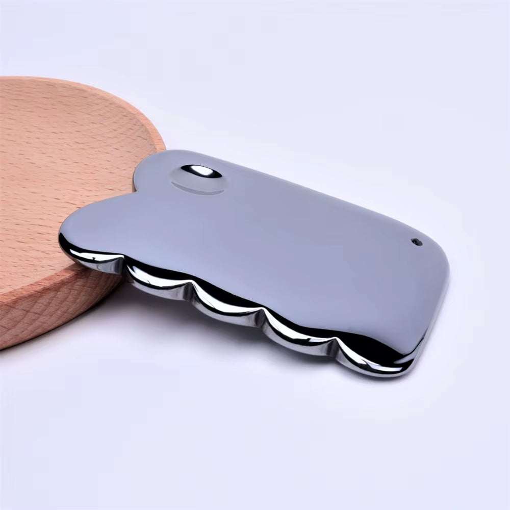 Terahertz Gua Sha scraper facial massager on wooden surface, promotes lymphatic drainage and skin lifting.