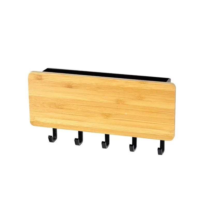 Wall-mounted bamboo key and coat hanger with five black hooks and a small shelf for home organization and space-saving storage.