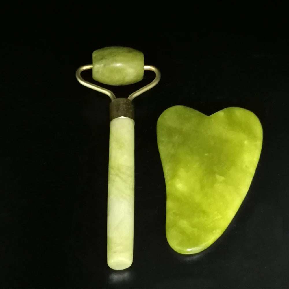 Natural jade face roller and gua sha set for skincare therapy.