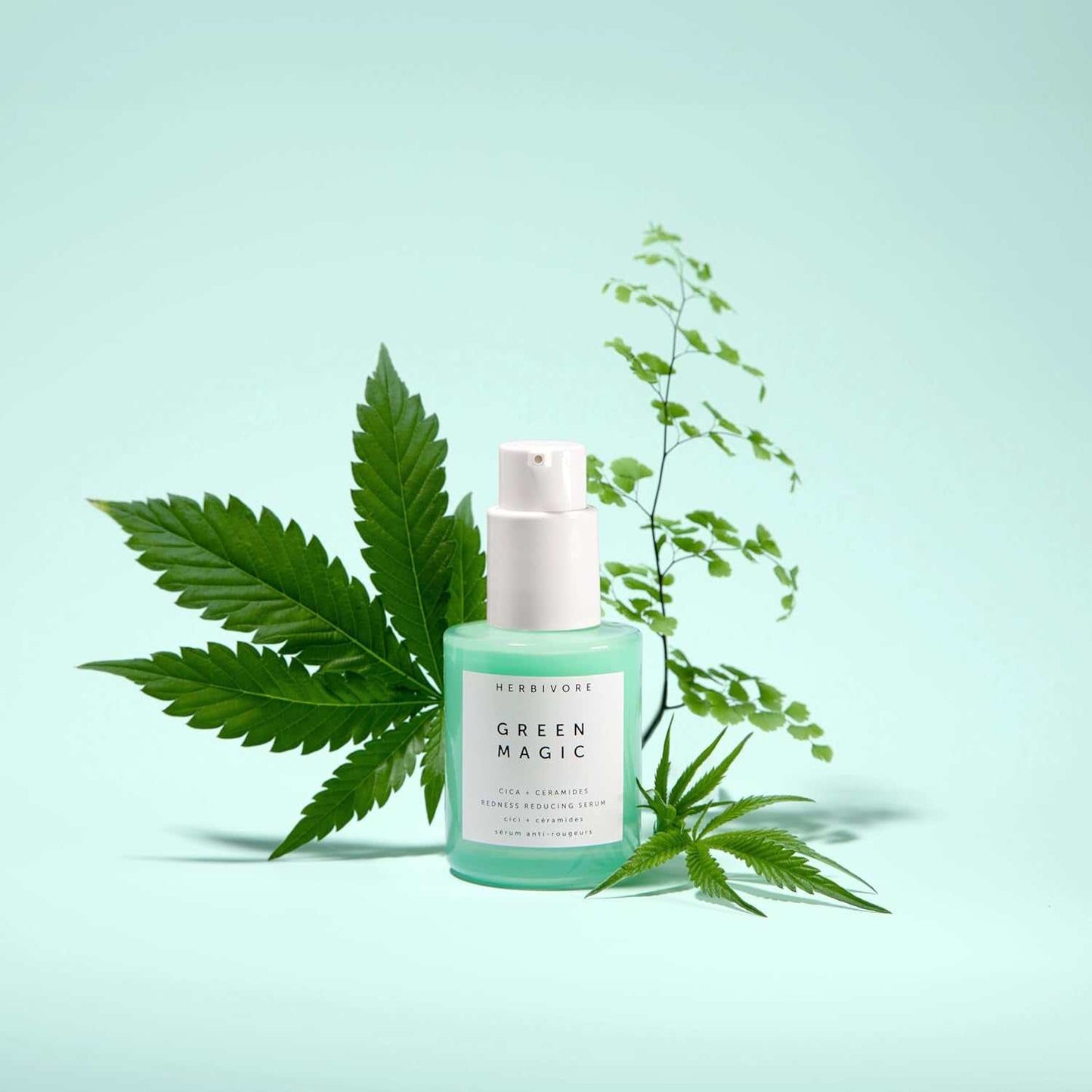 Green Magic Fast-Acting Serum bottle with surrounding green leaves, designed for redness reduction and hydration.