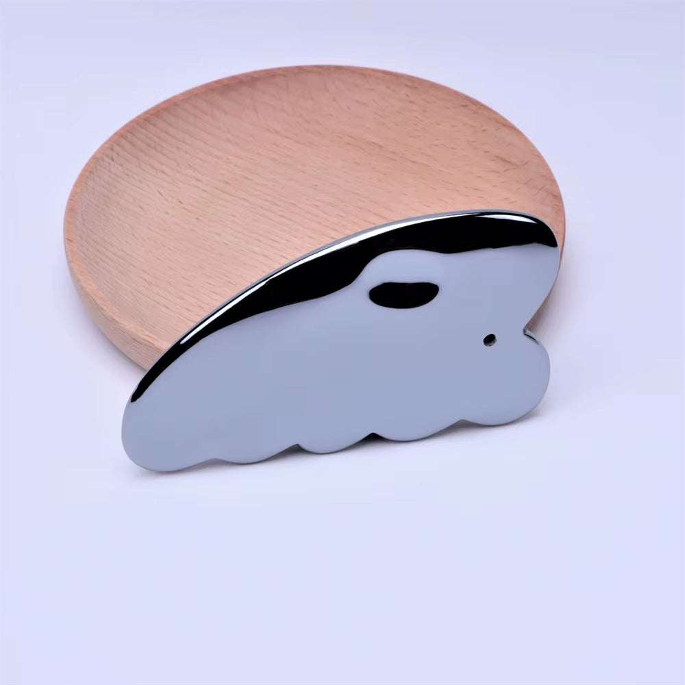Terahertz gua sha scraper facial massager on wooden surface promoting lymphatic drainage.