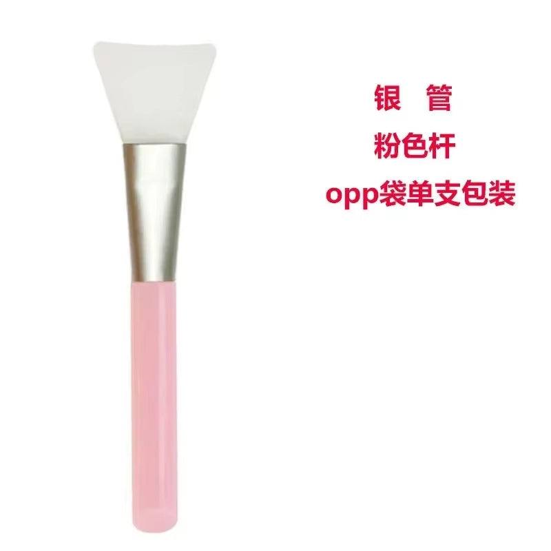 Silicone Facial Mask Brush with pink handle, ideal for applying skincare products smoothly.