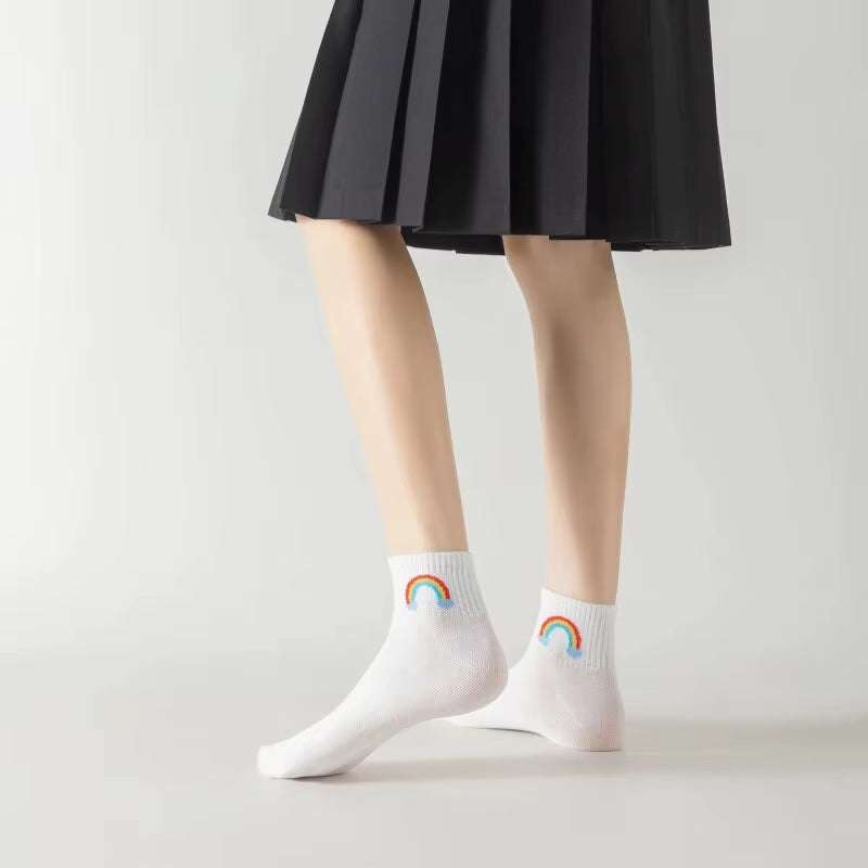 Women's white ankle socks with colorful rainbow design, featuring fun and smiling face pattern.