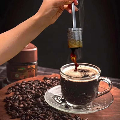 Reusable coffee filter in action, brewing fresh coffee over a glass cup, surrounded by coffee beans.